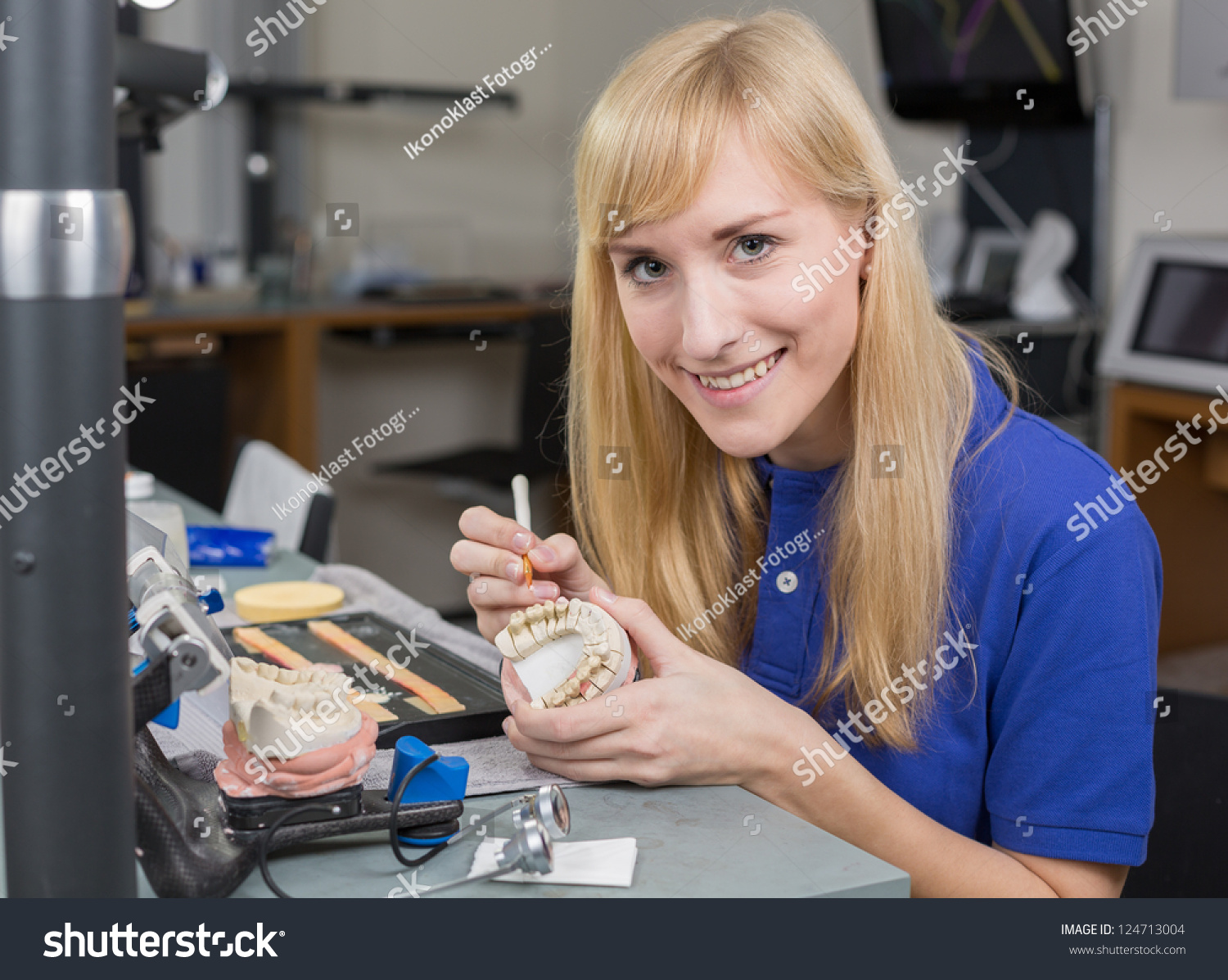 Dental Lab Technician Applying Porcelain To Dentition Mold In A Lab ...