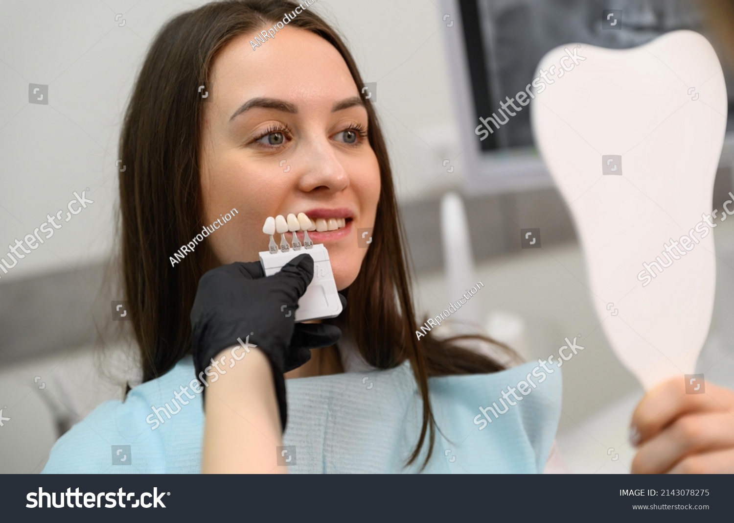 Stock Photo Dentist At Work In Dental Clinic Matching The Shades Of The Implants Using Shade Guide 2143078275 