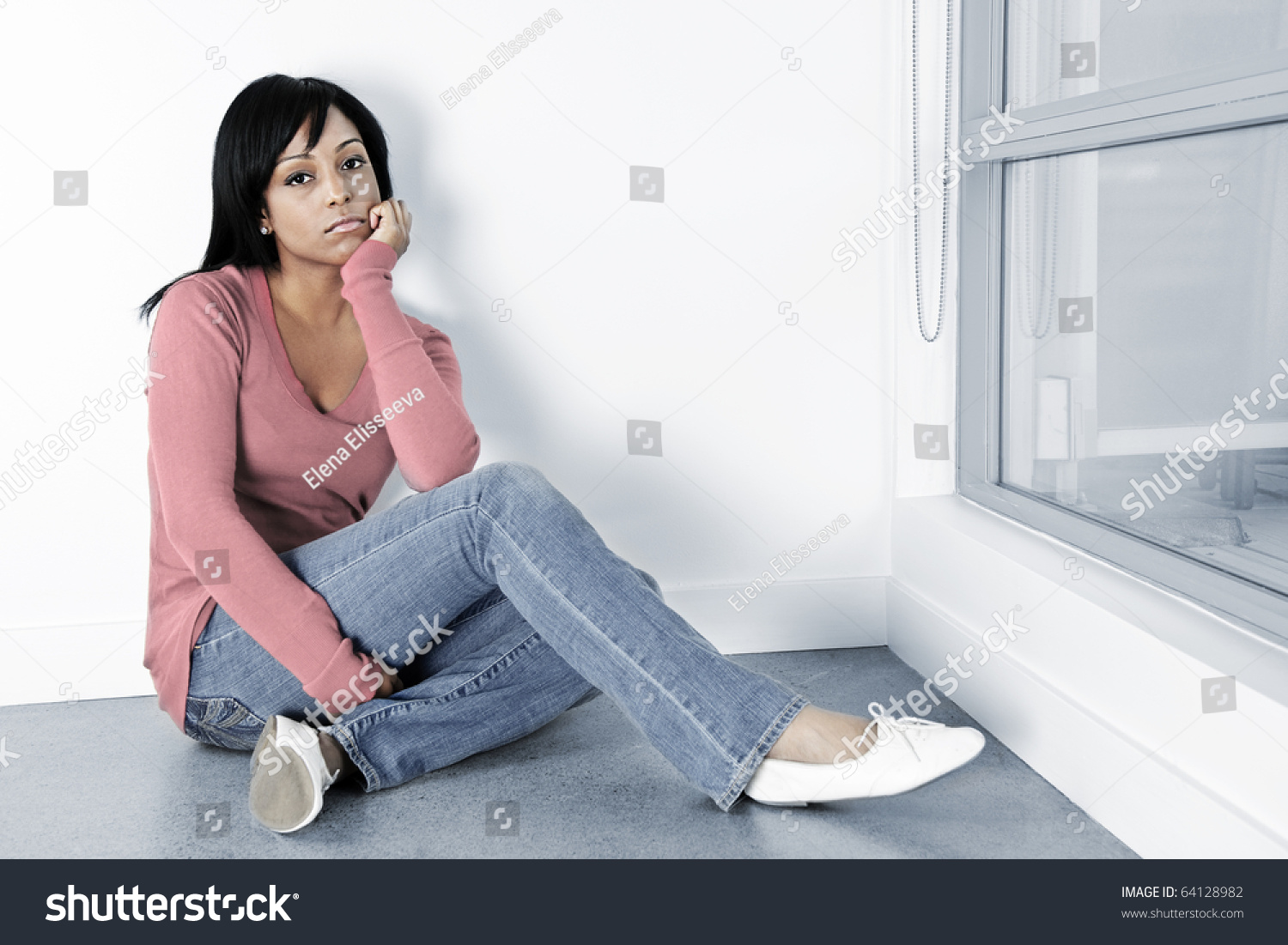 Depressed Black Woman Sitting On The Floor Against Wall Stock Photo ...