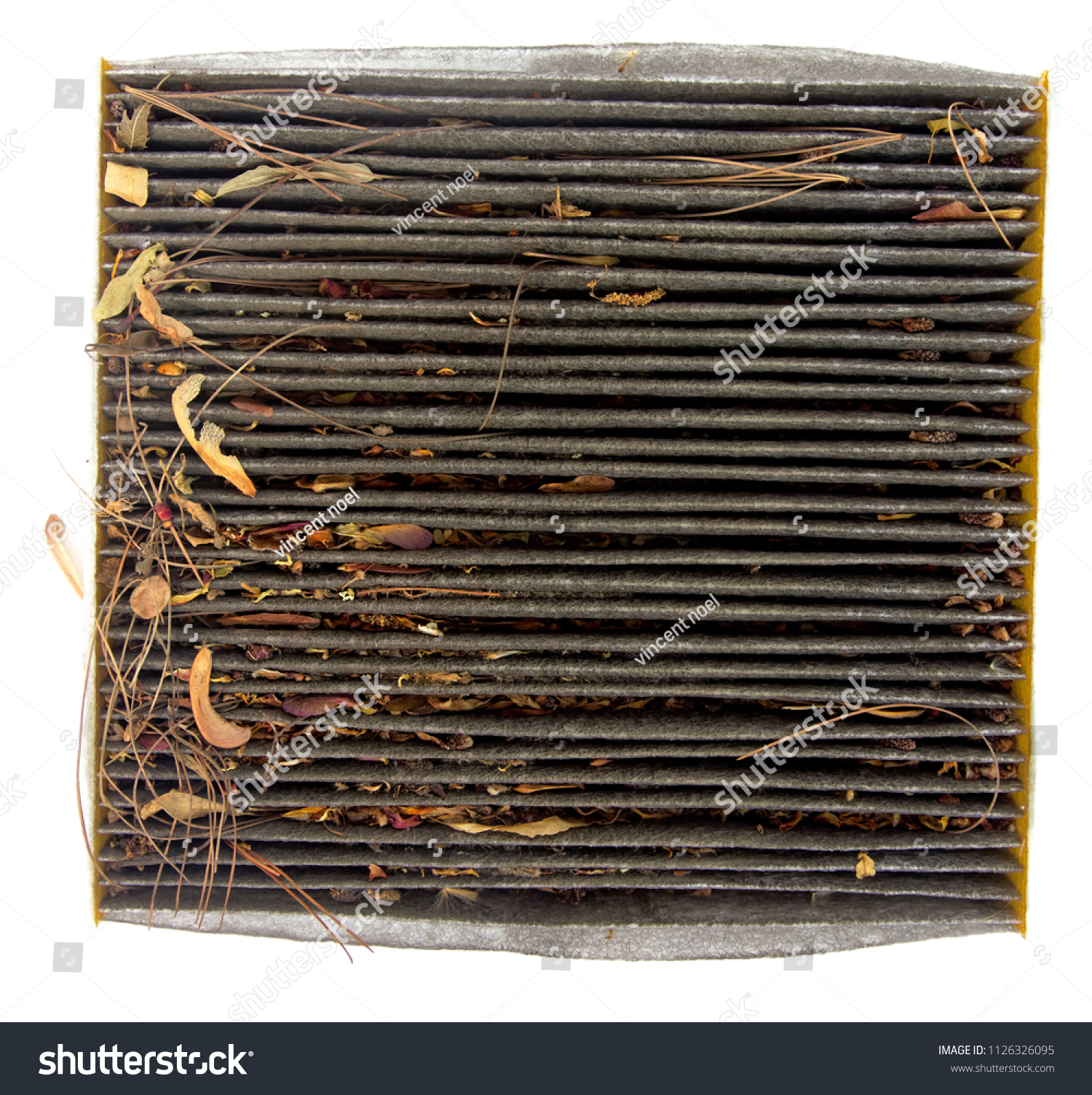 Dirty automobile cabin air filter clogged with dirt, dust and organic debris. Isolated.
