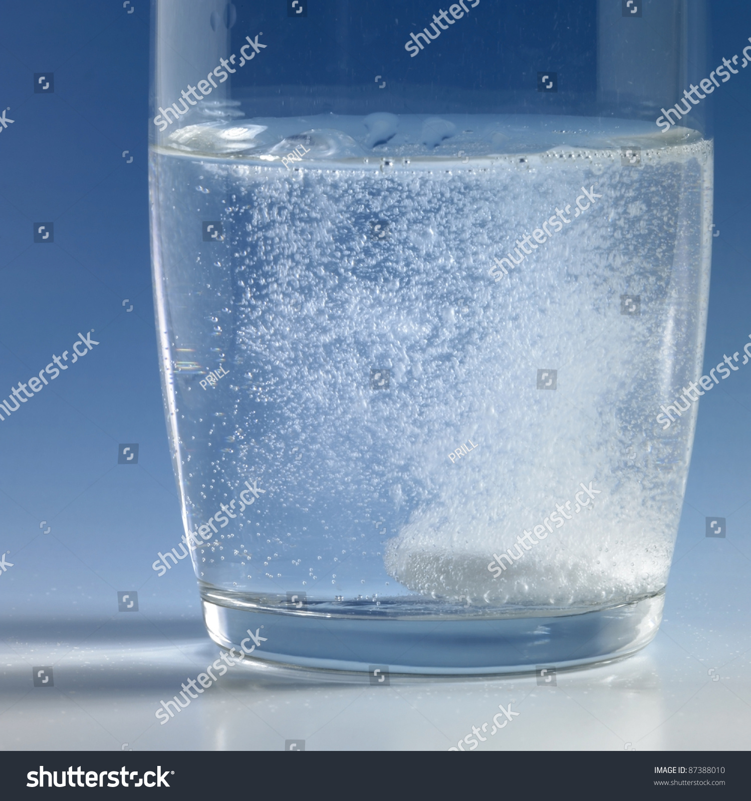 Dissolving Fizzy Tablet Floating In A Glass Of Water. Studio ...