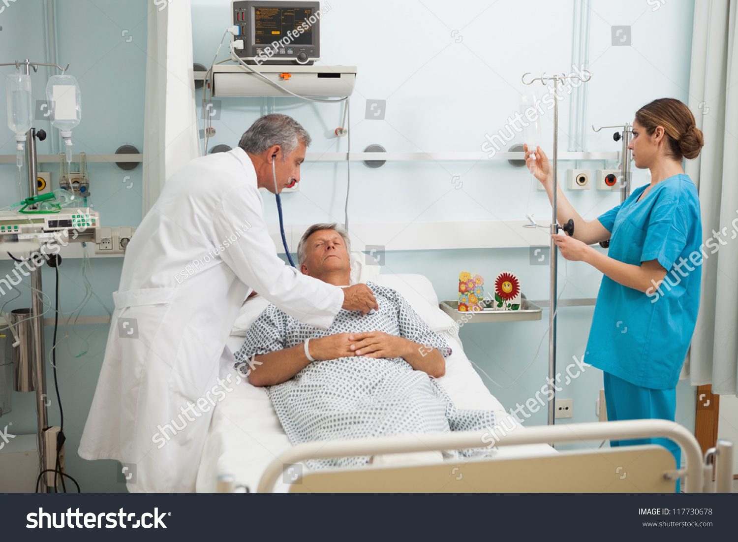 Doctor Checking Heart Beat Of Patient In Bed With Stethoscope With ...