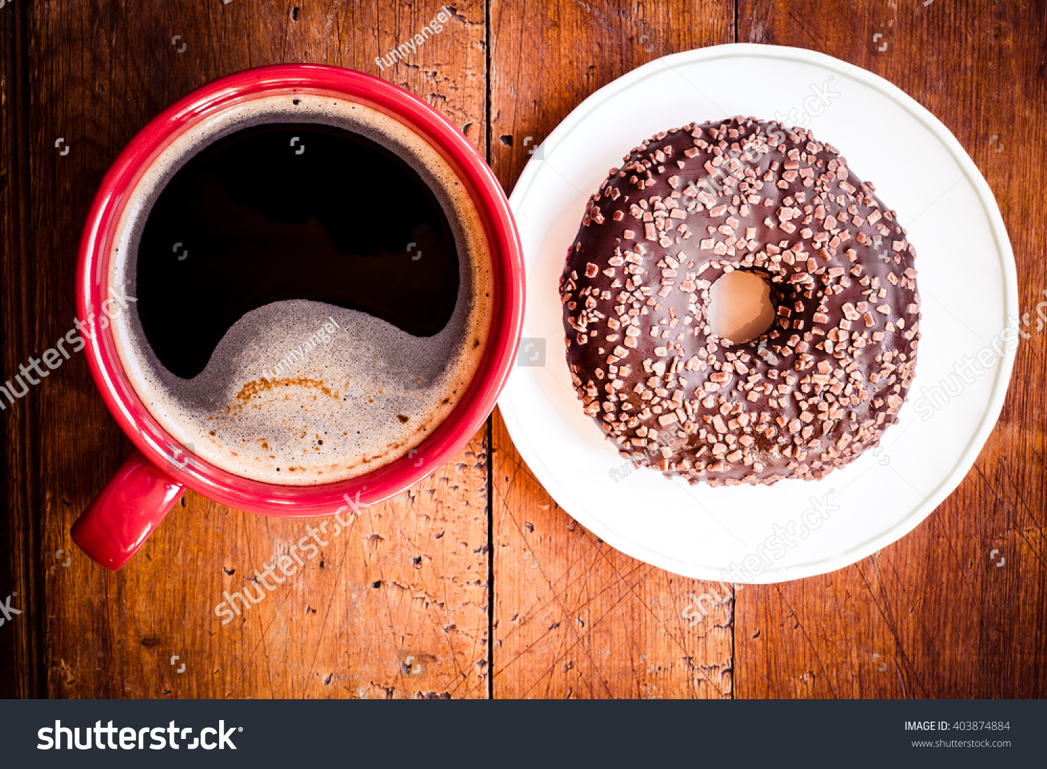 Doughnut. Sweet food and red cup of coffee, tea drink. Breakfast, dessert with cake, snack. Brown wooden table. Bakery, sugar doughnut. Tasty espresso black hot morning beverage. 