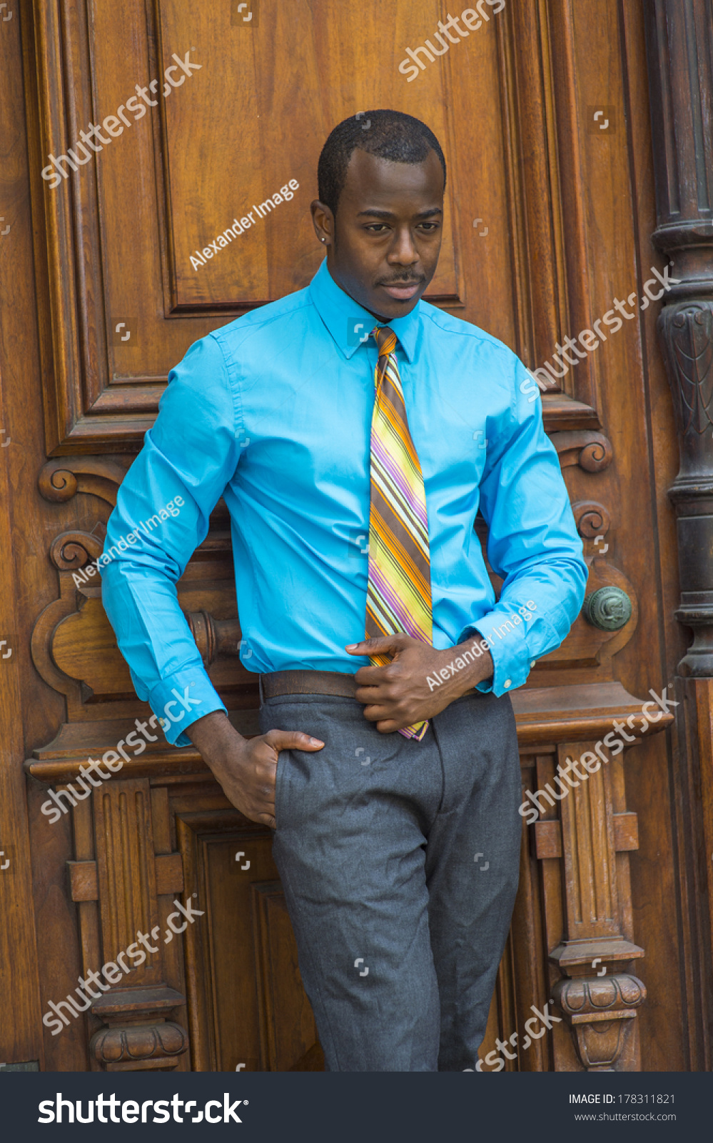 light blue shirt and gray pants