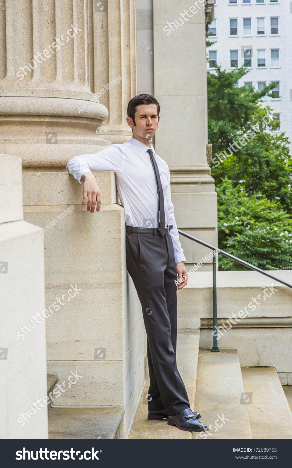 Man in white dress shirt and black pants leaning on gray concrete wall  photo  Free Grey Image on Unsplash