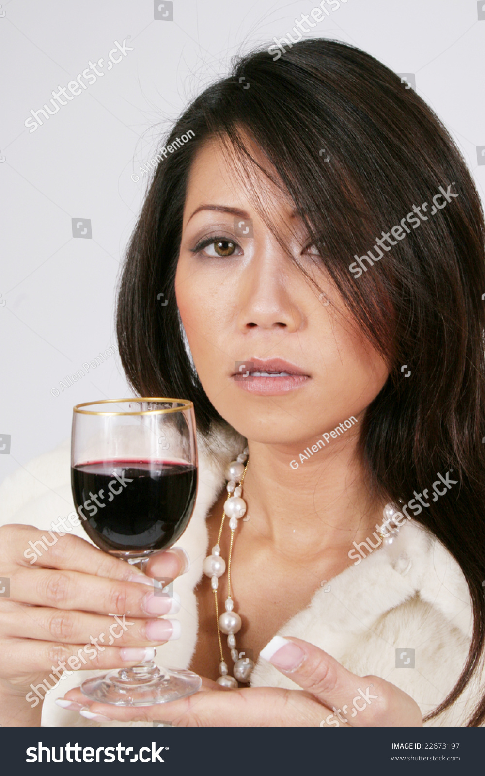 Elegant Woman Holding A Glass Of Red Wine And Wearing A Fur Jacket And ...