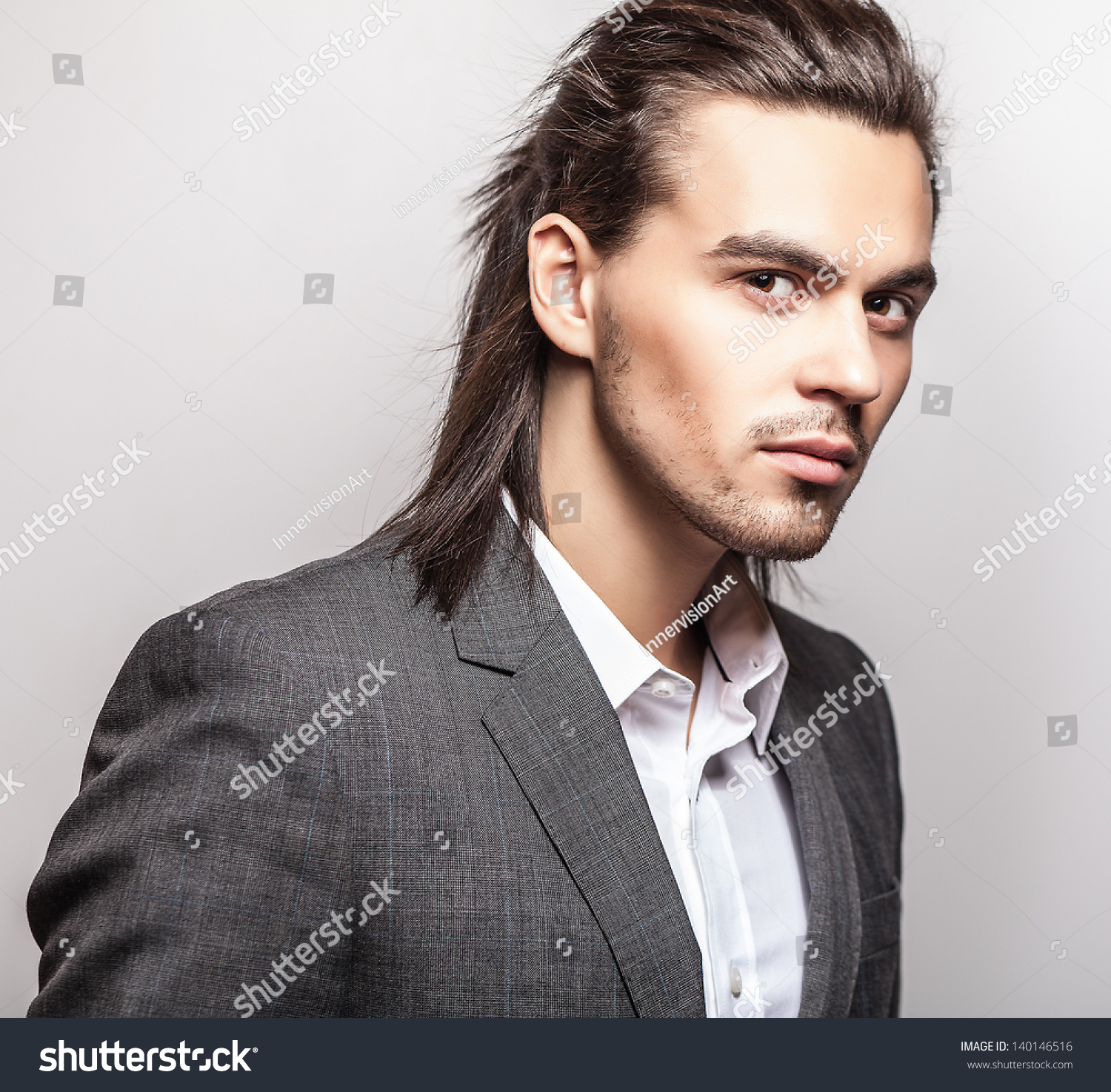 Elegant Young Handsome Long-Haired Man In Costume. Studio Fashion ...