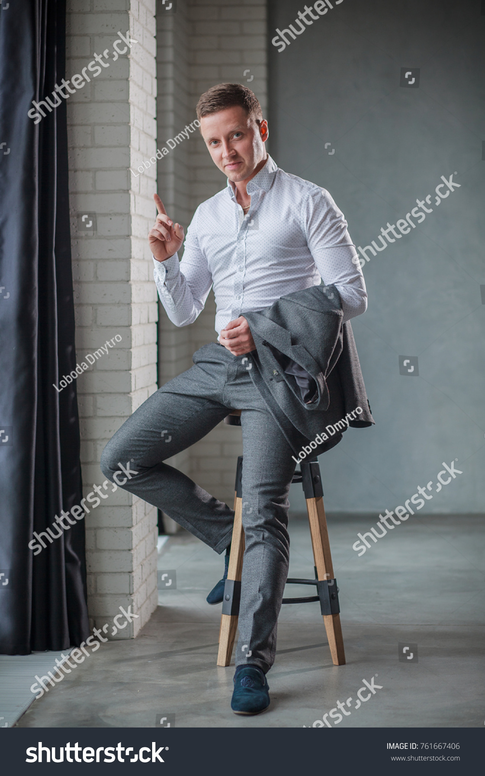 Elegant Young Man Sitting On Stool Stock Photo Edit Now 761667406   Stock Photo Elegant Young Man Sitting On A Stool 761667406 