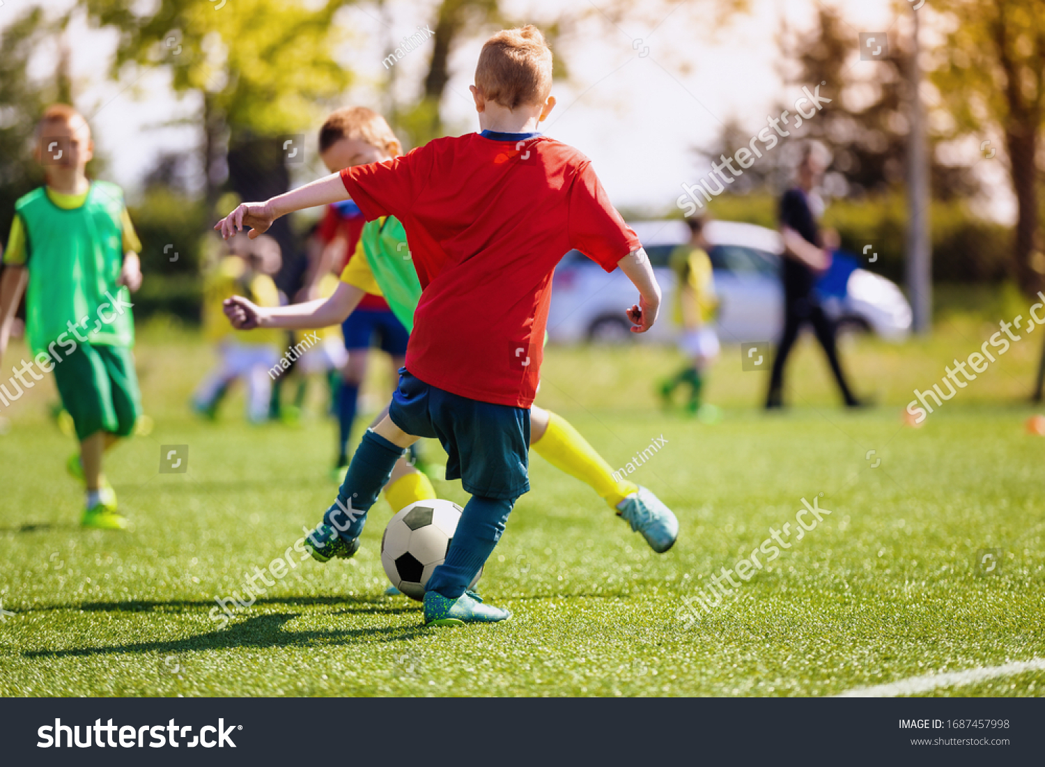 elementary-school-kids-playing-football-field-stock-photo-1687457998