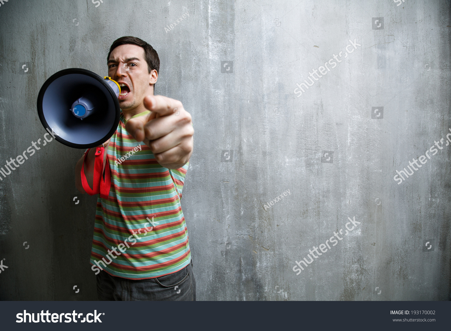 Emotional Man Yells Into A Megaphone And Points On The Background Of ...