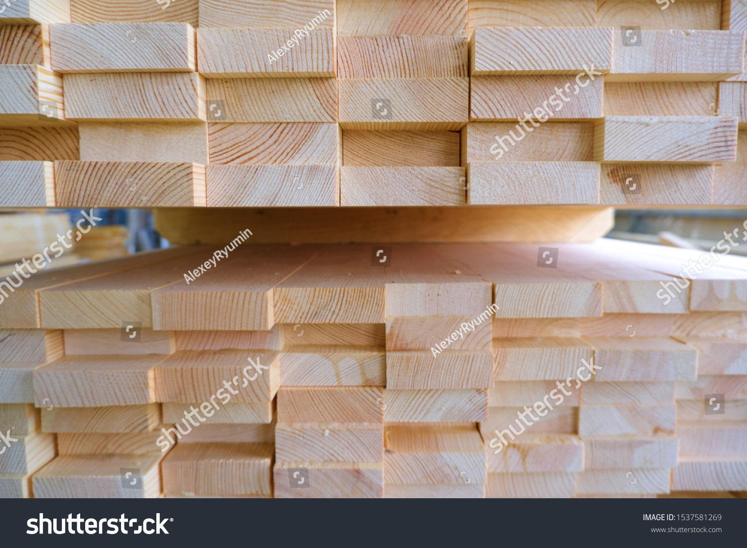 End view of stack of three-layer wooden glued laminated timber beams from pine finger joint spliced boards for wooden windows.