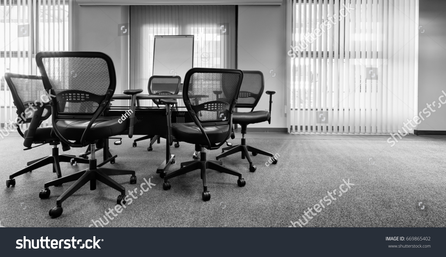 ergonomic office chairs around small conference stock photo edit