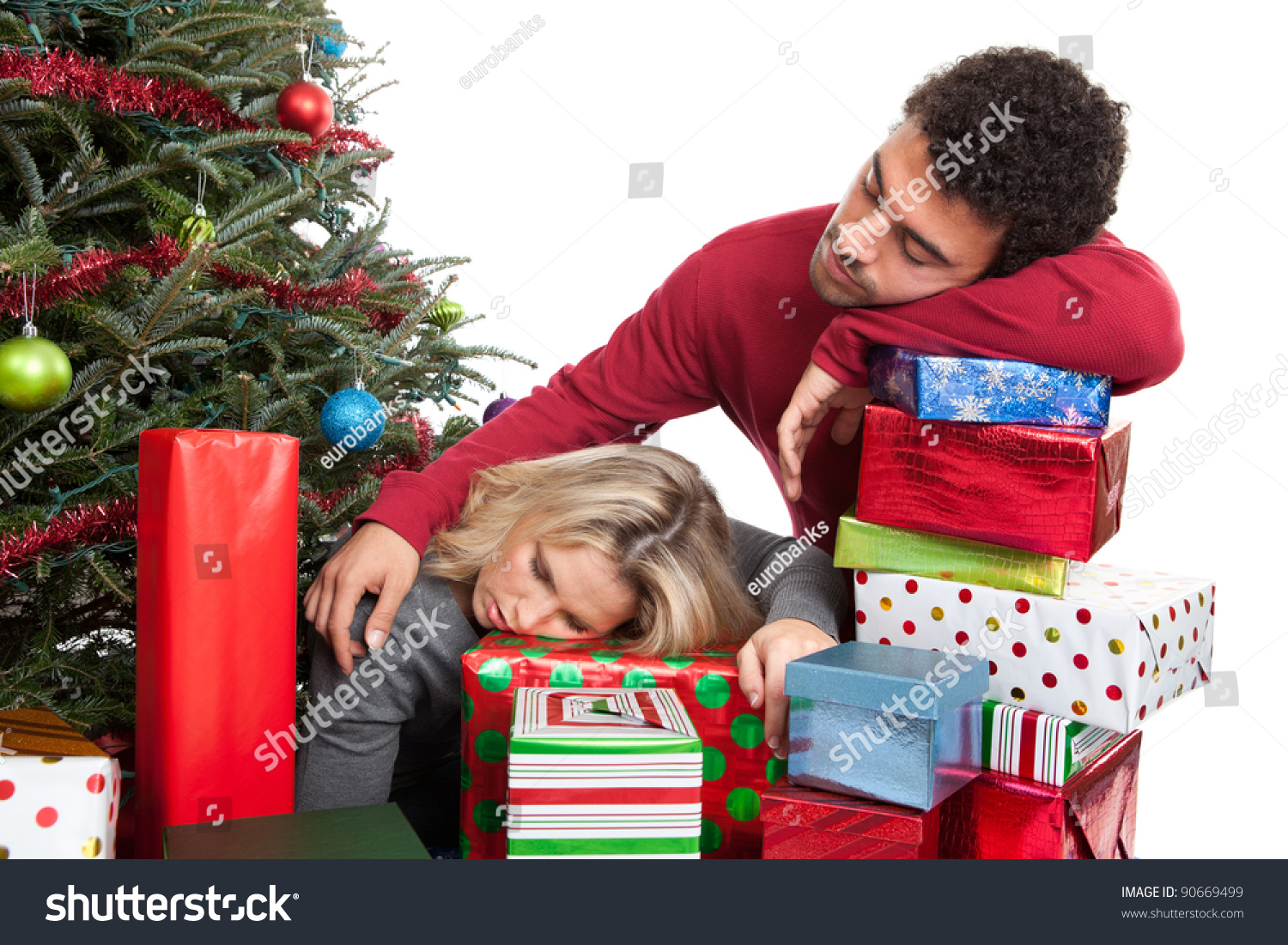 Exhausted Couple Sleeping On Christmas Presents Stock Photo 90669499