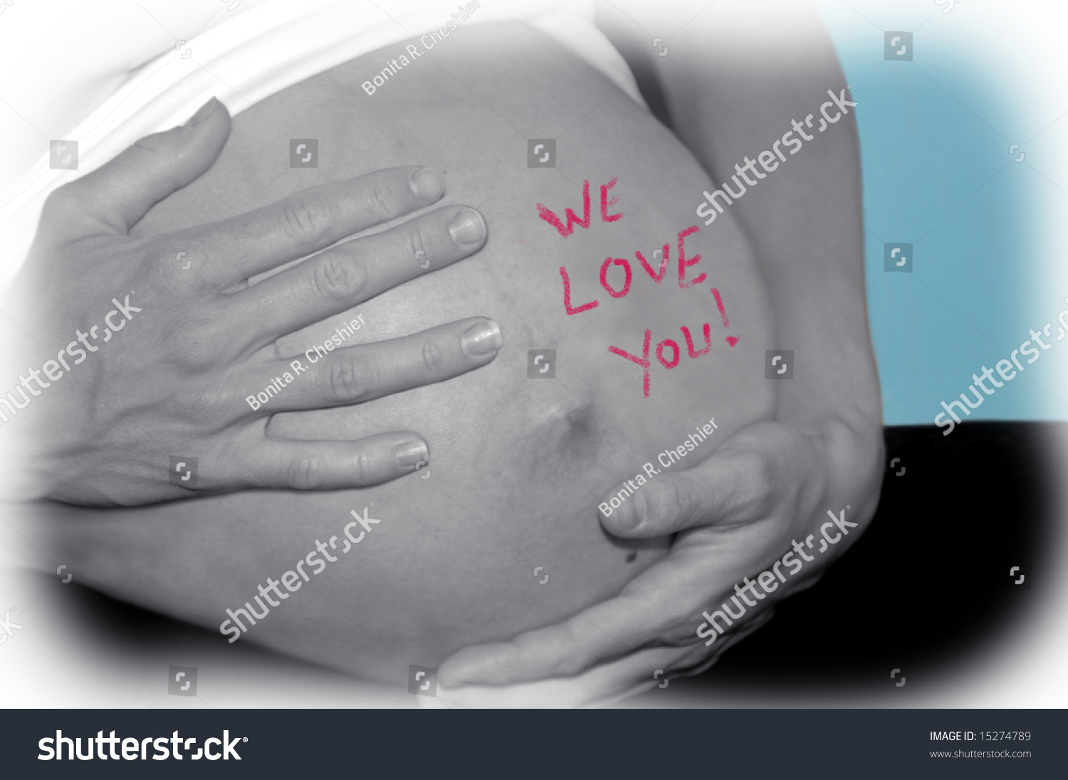 Expecting Mom Cradles Her Tummy With Both Hands. The Words 