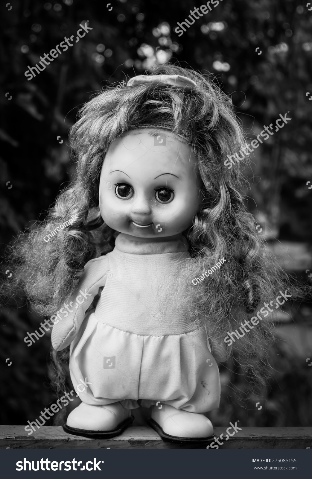 creepy girl with black hair and doll