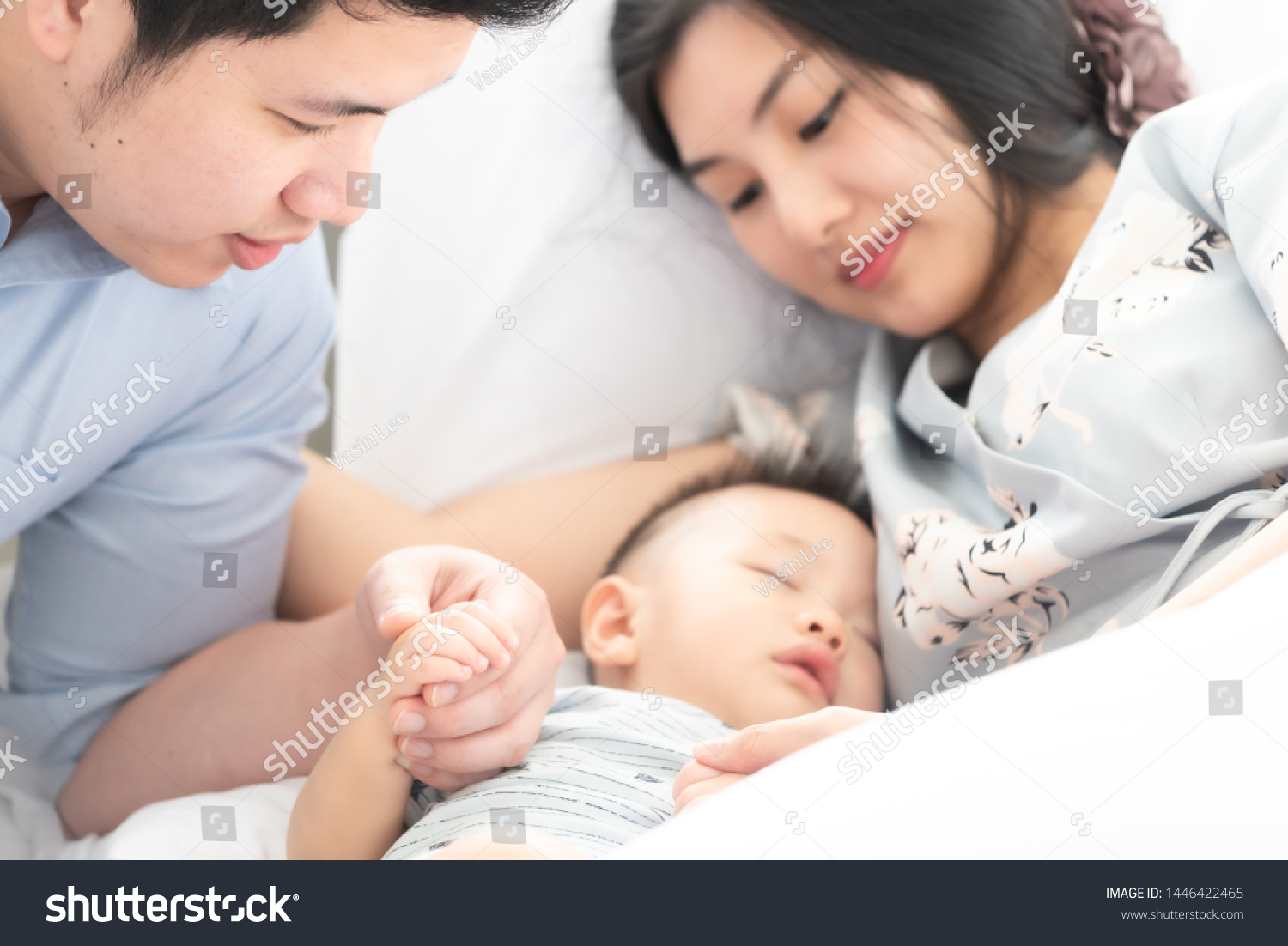 mom and dad sleeping with baby