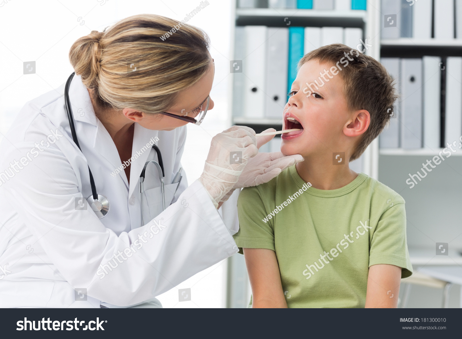 Female Doctor Checking Mouth Boy Clinic Stock Photo 181300010 ...