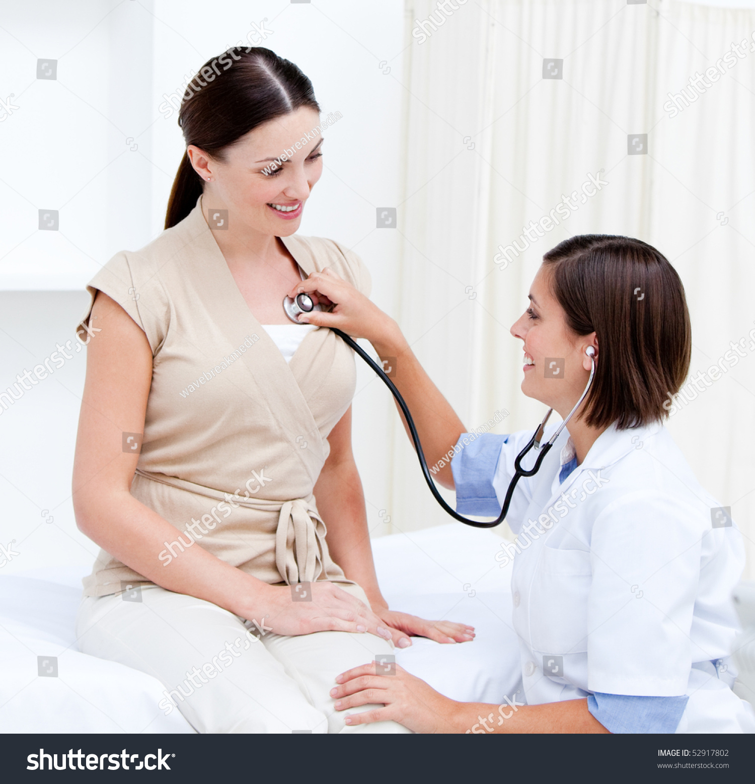 Female Doctor Examining Smiling Female Patient Stock Photo 52917802 - Shutterstock-5556