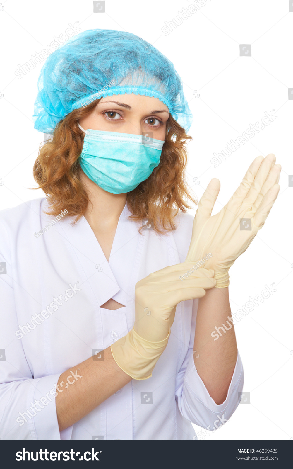 Female Doctor In Uniform And Medical Mask Pulling On Surgical Gloves ...