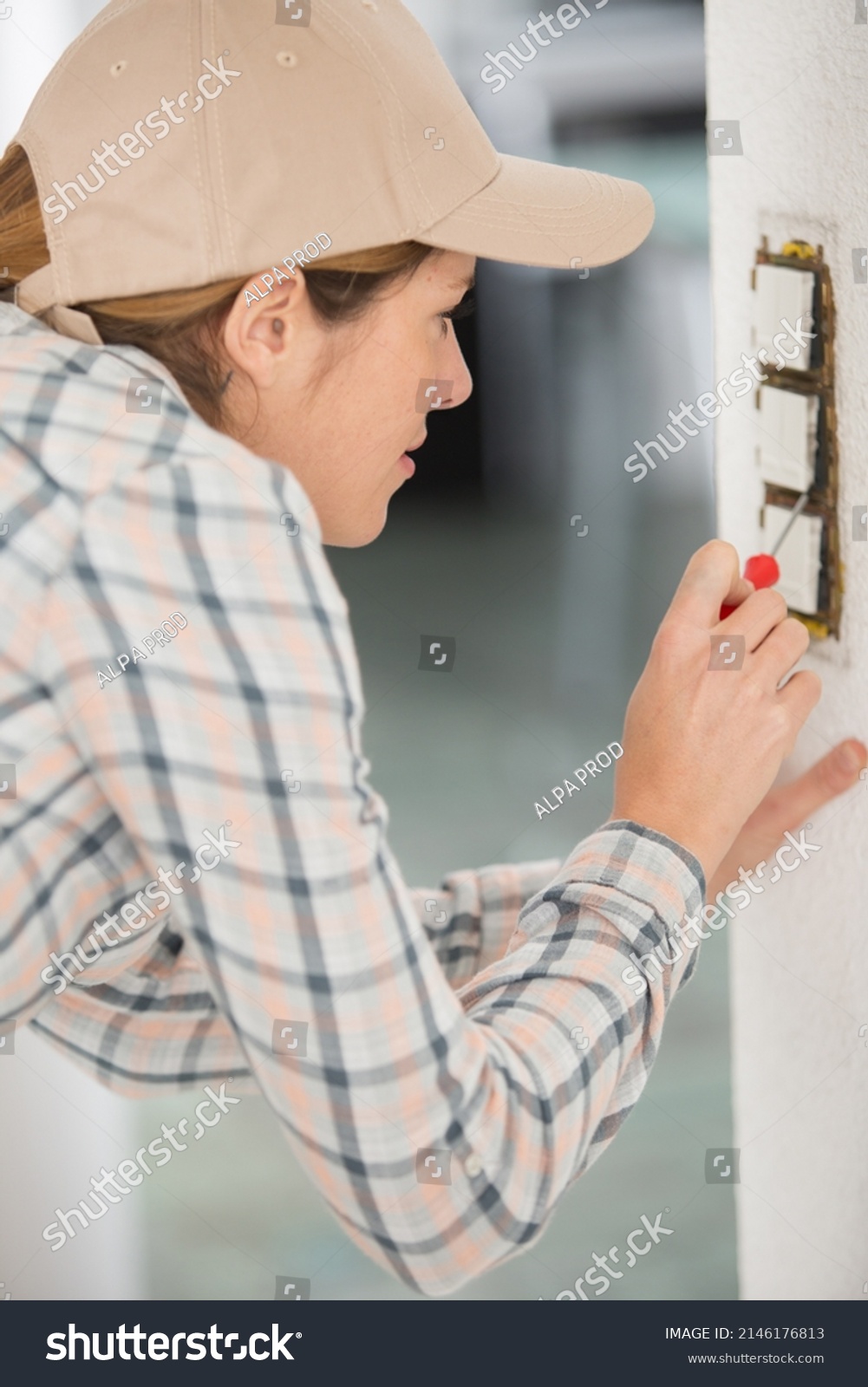 Female Electrician Testing Wall Socket Stock Photo 2146176813 Female Electrician Testing Wall Socket Stock Photo 2146176813