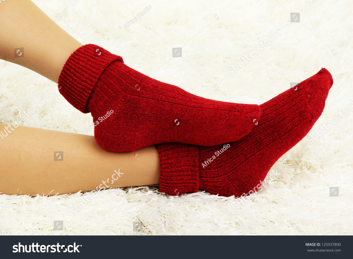 Female Legs In Colorful Socks On White Carpet Background Stock Photo ...