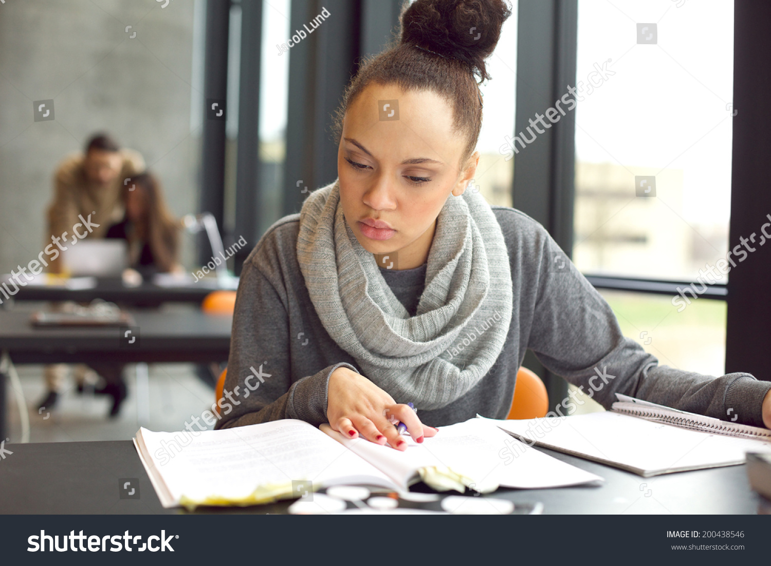 Female Student Reading A Book For Finding Information. Young African ...