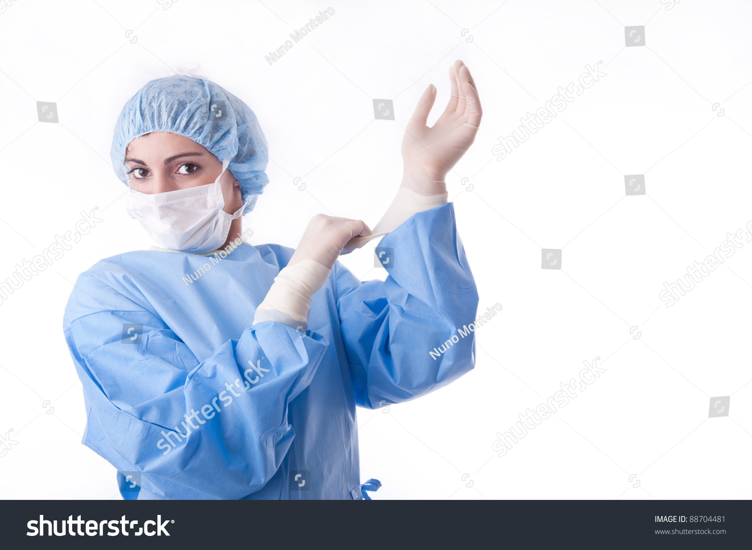 Female Surgeon Or Nurse Wearing A Sterile Blue Suit Putting On Sterile ...