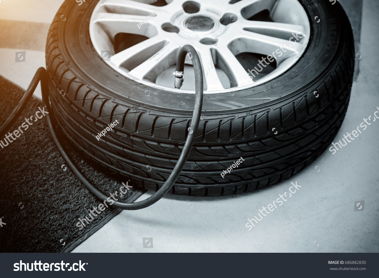 pumping air into car tires