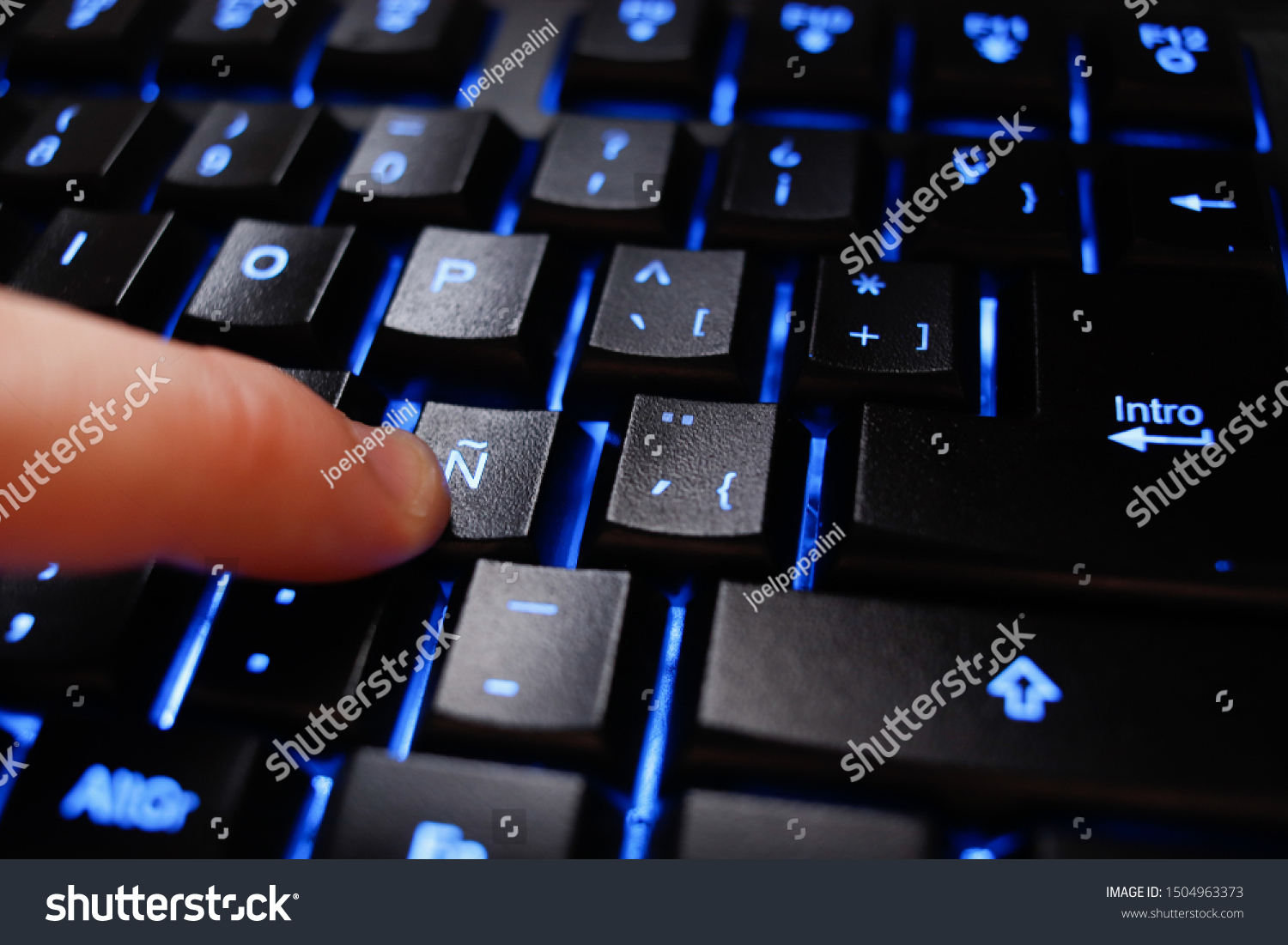 Finger Over Backlighted Keyboard Pressing Spanish Stock Photo Edit Now