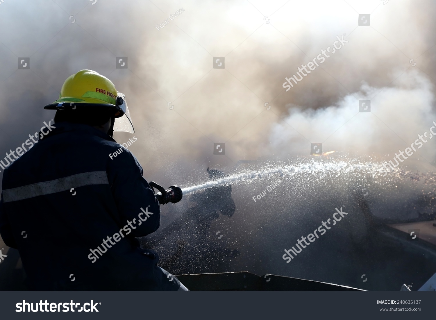 Fireman Spraying Water On Burnt Out Stock Photo 240635137 - Shutterstock