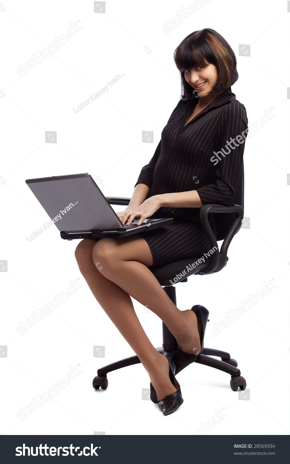 Flirting Brunette Woman In Dark Dress Sitting In The Office Chair And ...