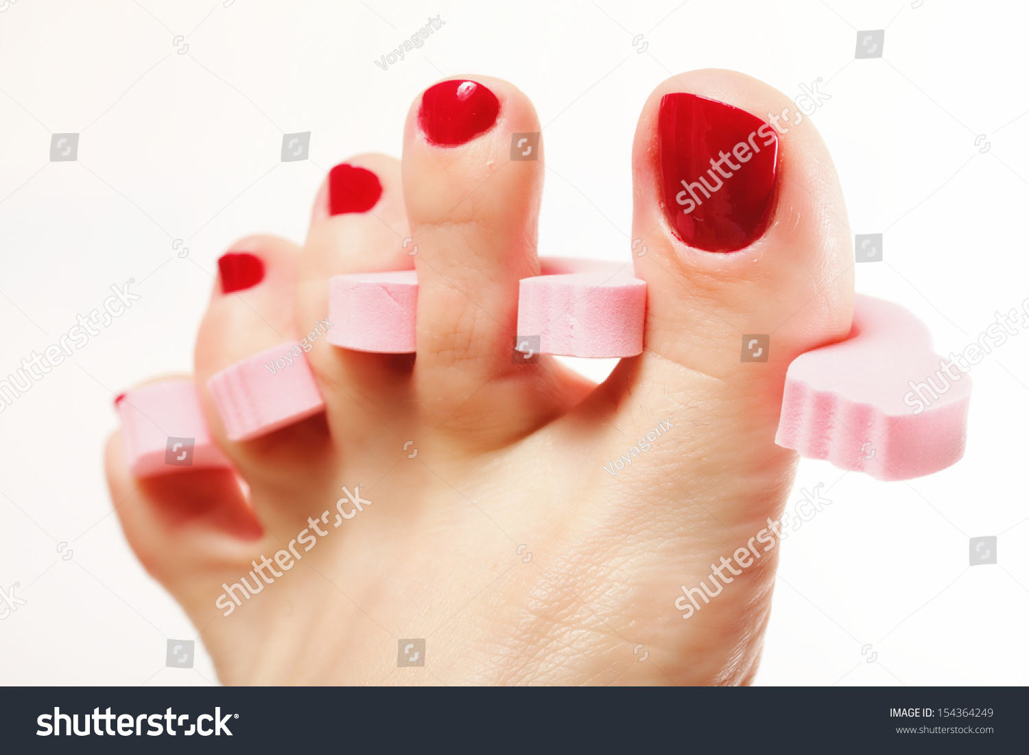 Foot Pedicure Applying Woman'S Feet With Red Toenails In Toe Separators ...