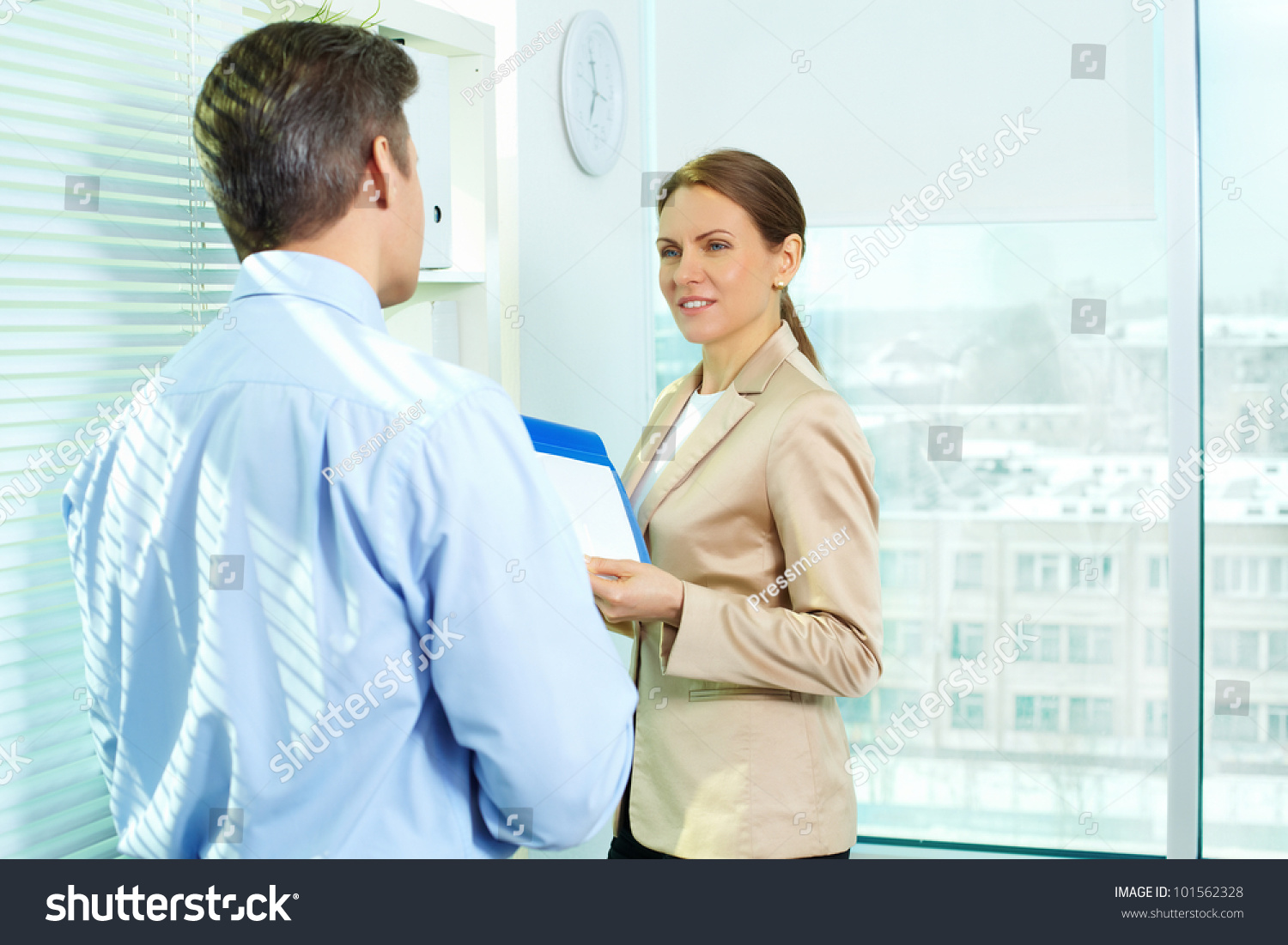 Formally Dressed Young People Interacting In Office Stock Photo ...