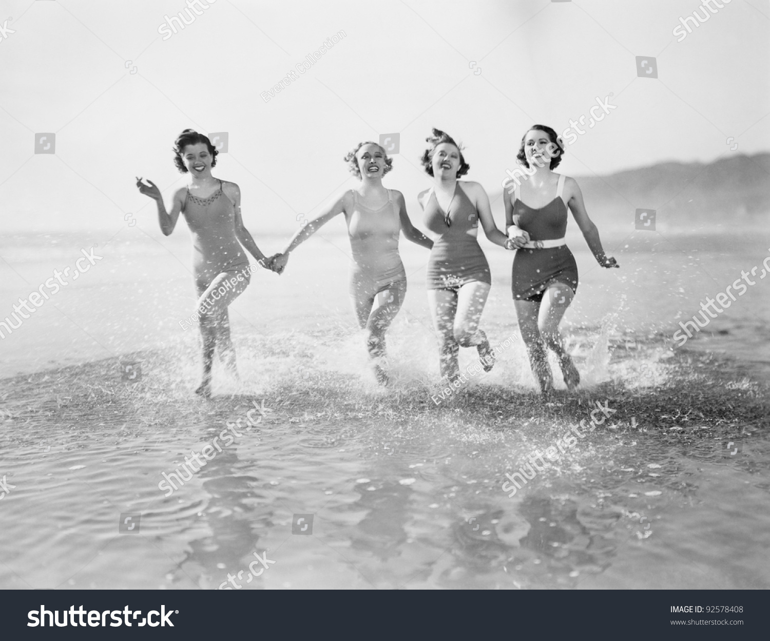 Four Women Running In Water On The Beach Stock Photo 92578408 ...