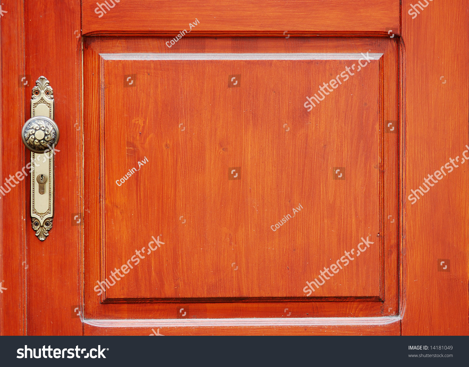 Fragment of wooden door with a keyhole and handle