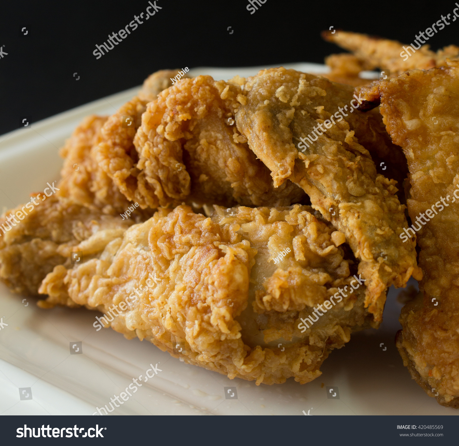 Fried Chicken On White Plate , Black Background Stock Photo 420485569