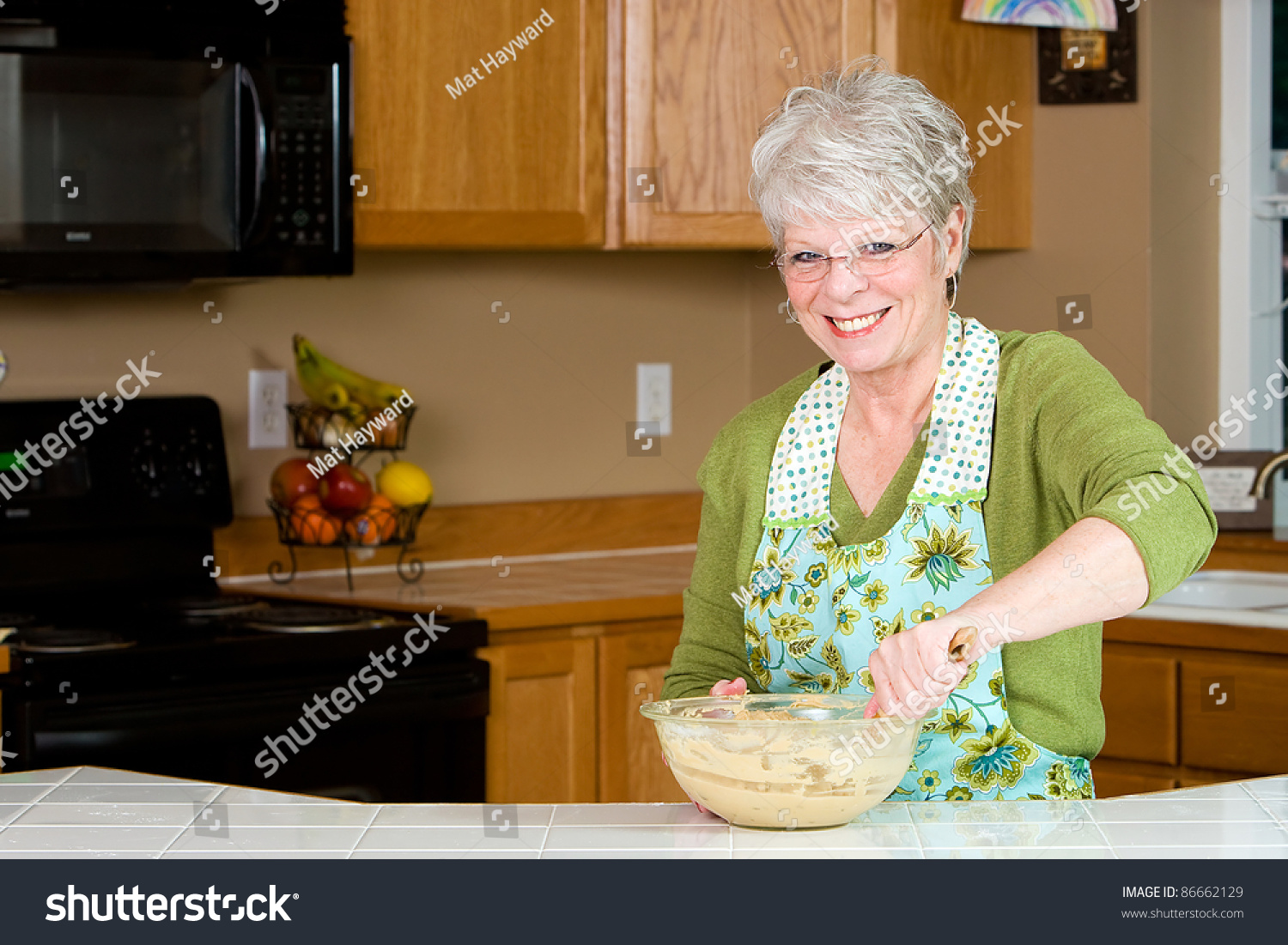 Friendly Mature Woman With A Nice Smile And White Hair Baking Cookies ...