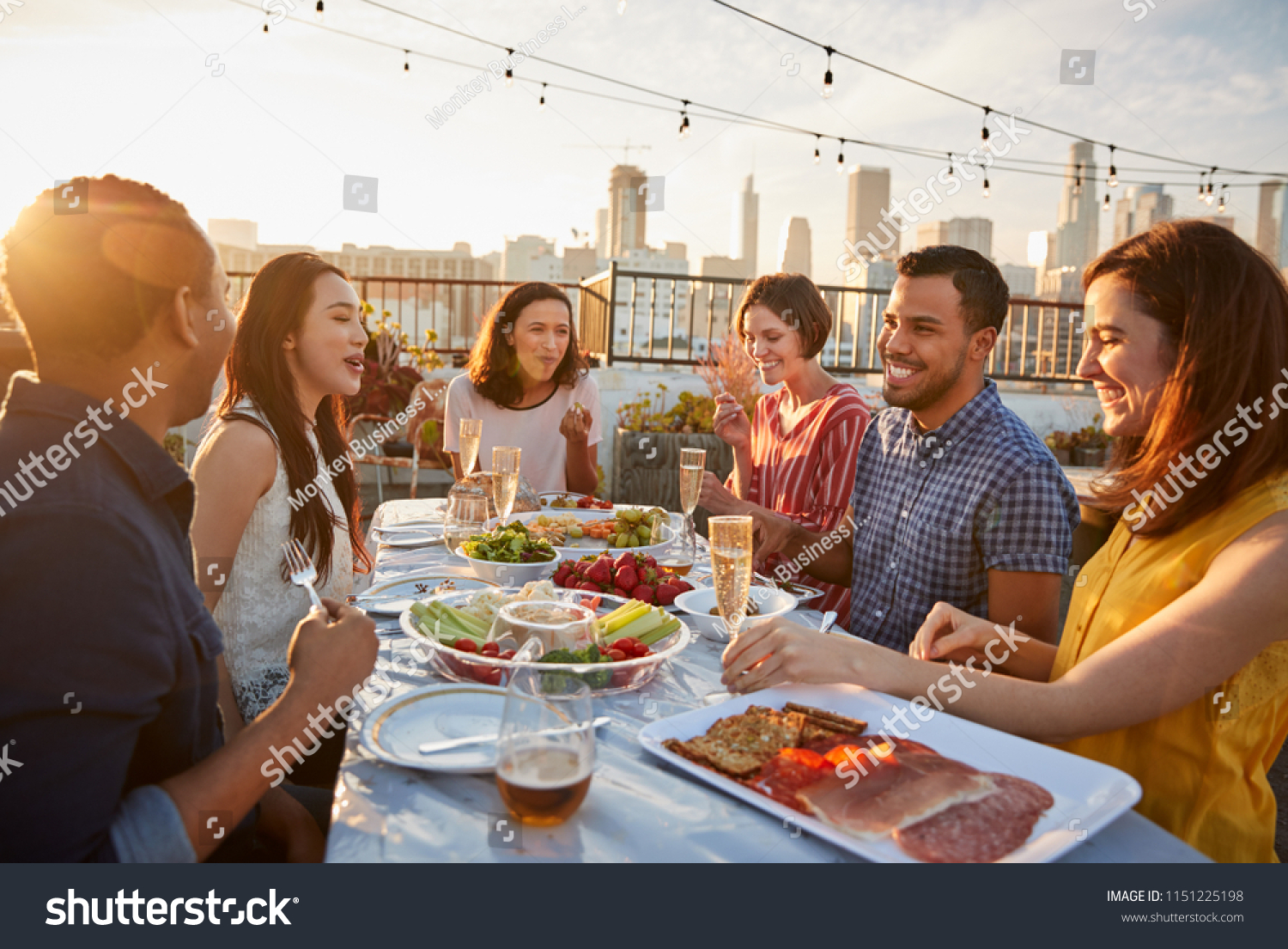 Friends Gathered On Rooftop Terrace Meal People Stock Image