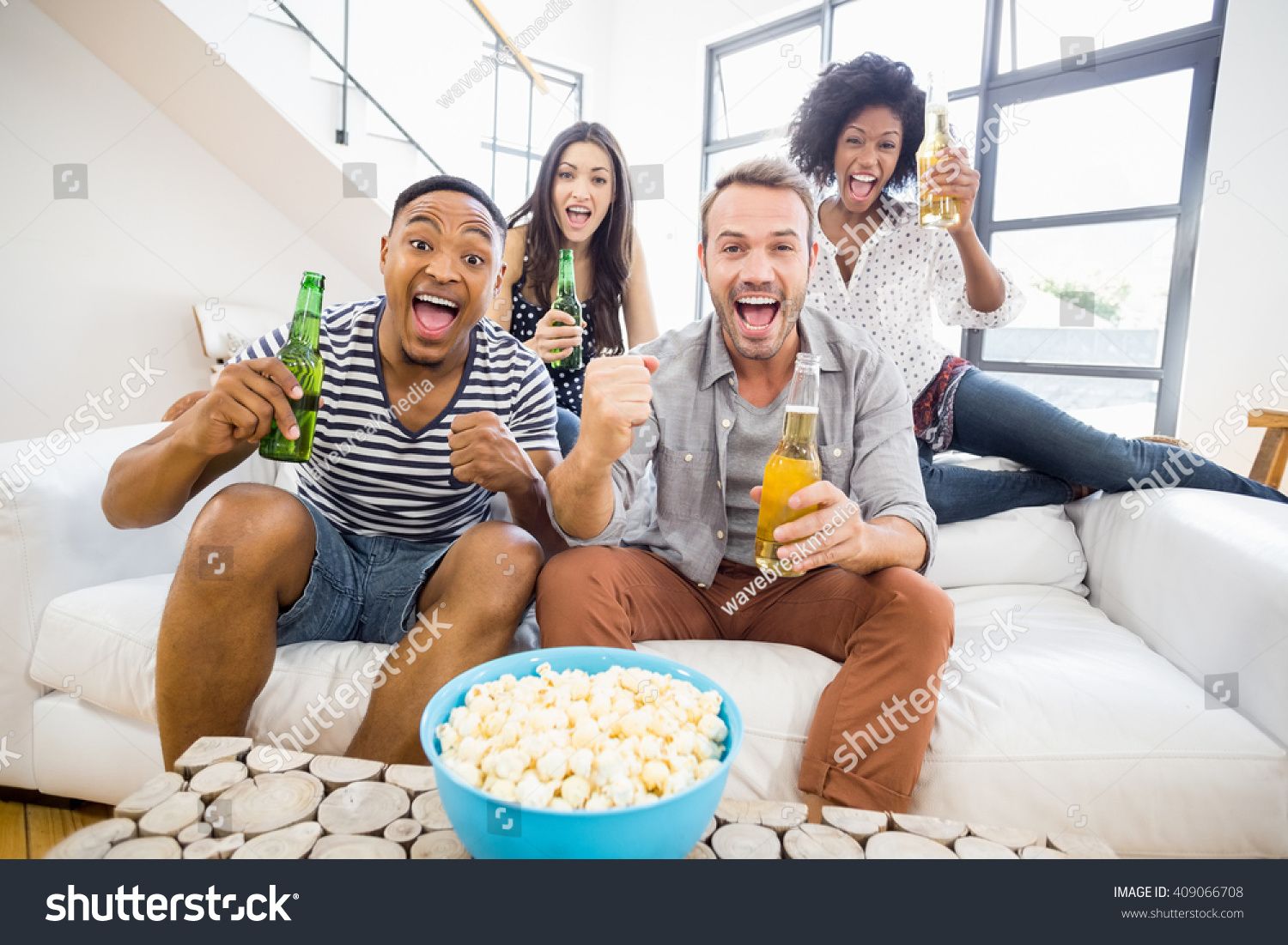 Friends Sitting On Sofa Holding Beer Stock Photo 409066708 - Shutterstock