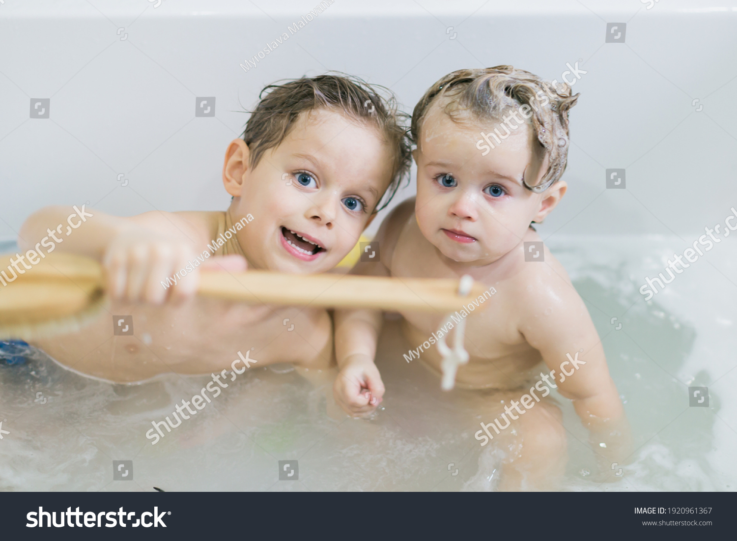 Young lass having fun in the bath