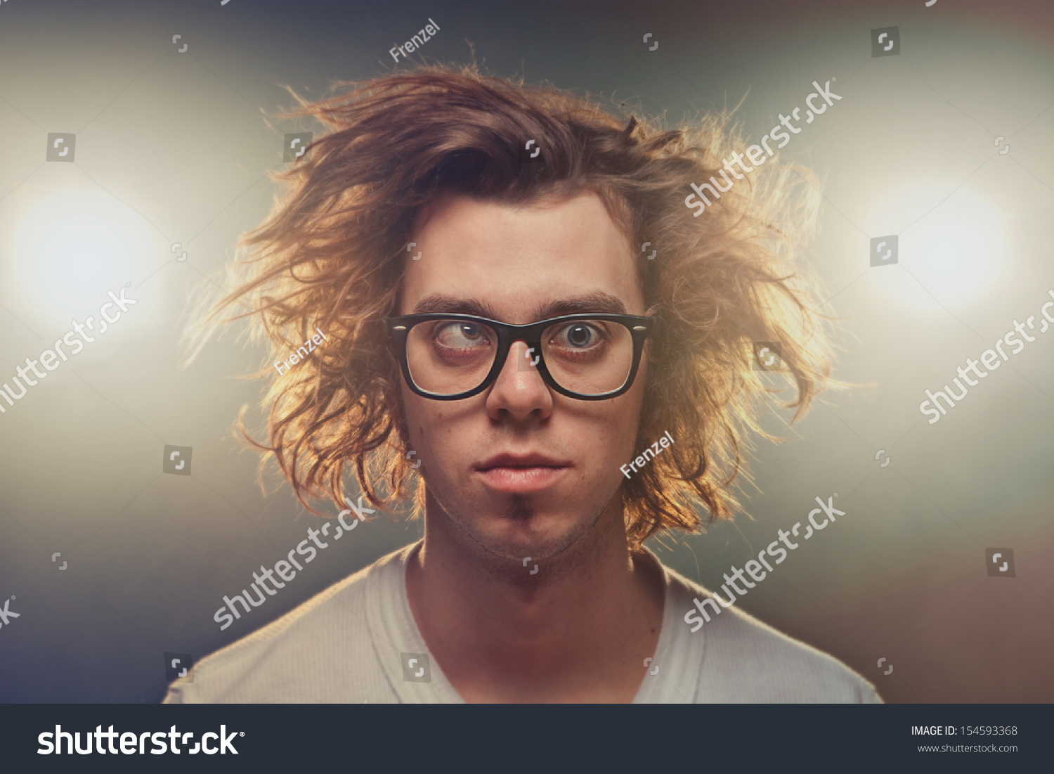stock-photo-funny-squinting-man-with-tousled-brown-hair-in-studio-using-spotlights-in-background-154593368.jpg