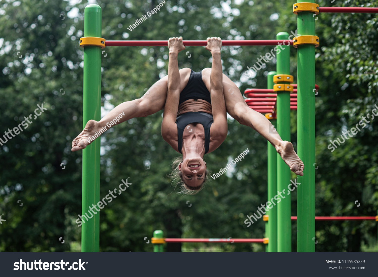 https://image.shutterstock.com/z/stock-photo-girl-doing-exercises-on-the-horizontal-bar-in-the-open-air-the-woman-is-engaged-in-workout-1145985239.jpg