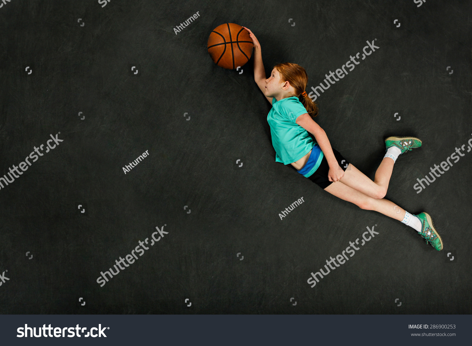 girl dunking basketball