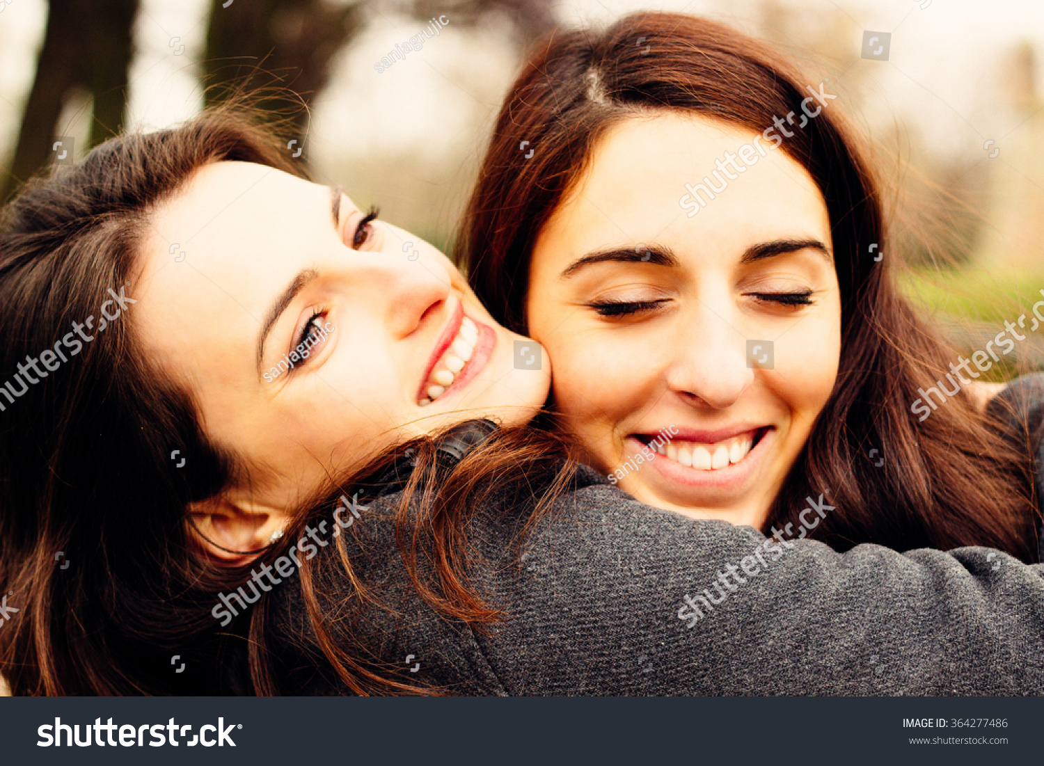 Girl Hugging Her Best Friend. In The Park Stock Photo 364277486 ...