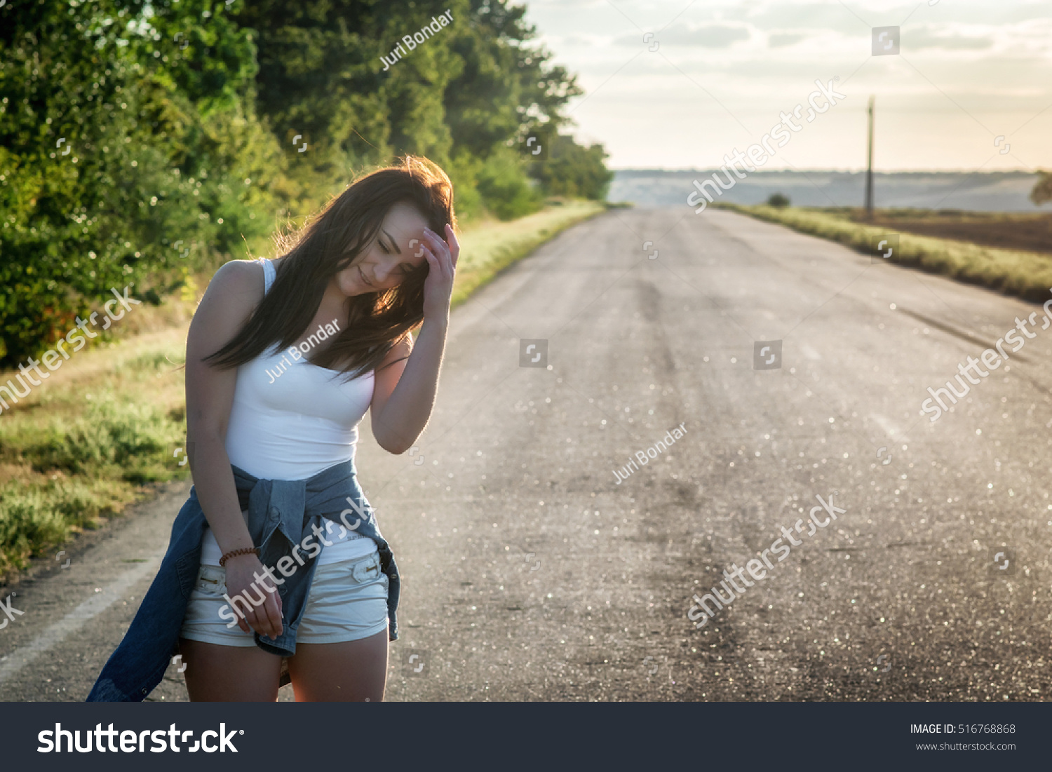 Girl In A White T Shirt And Shorts Bent Over The Road In An Girl In A White T Shirt And Shorts Bent Over The Road In An