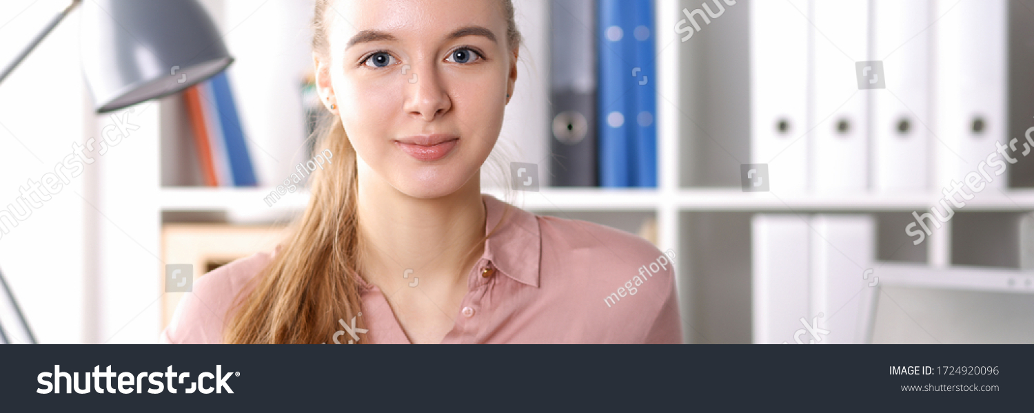 Girl in office on background folders and books. Enter profession with an internship. Student is not afraid difficulties, loves chosen profession. Convenient schedule and valuable practice for intern