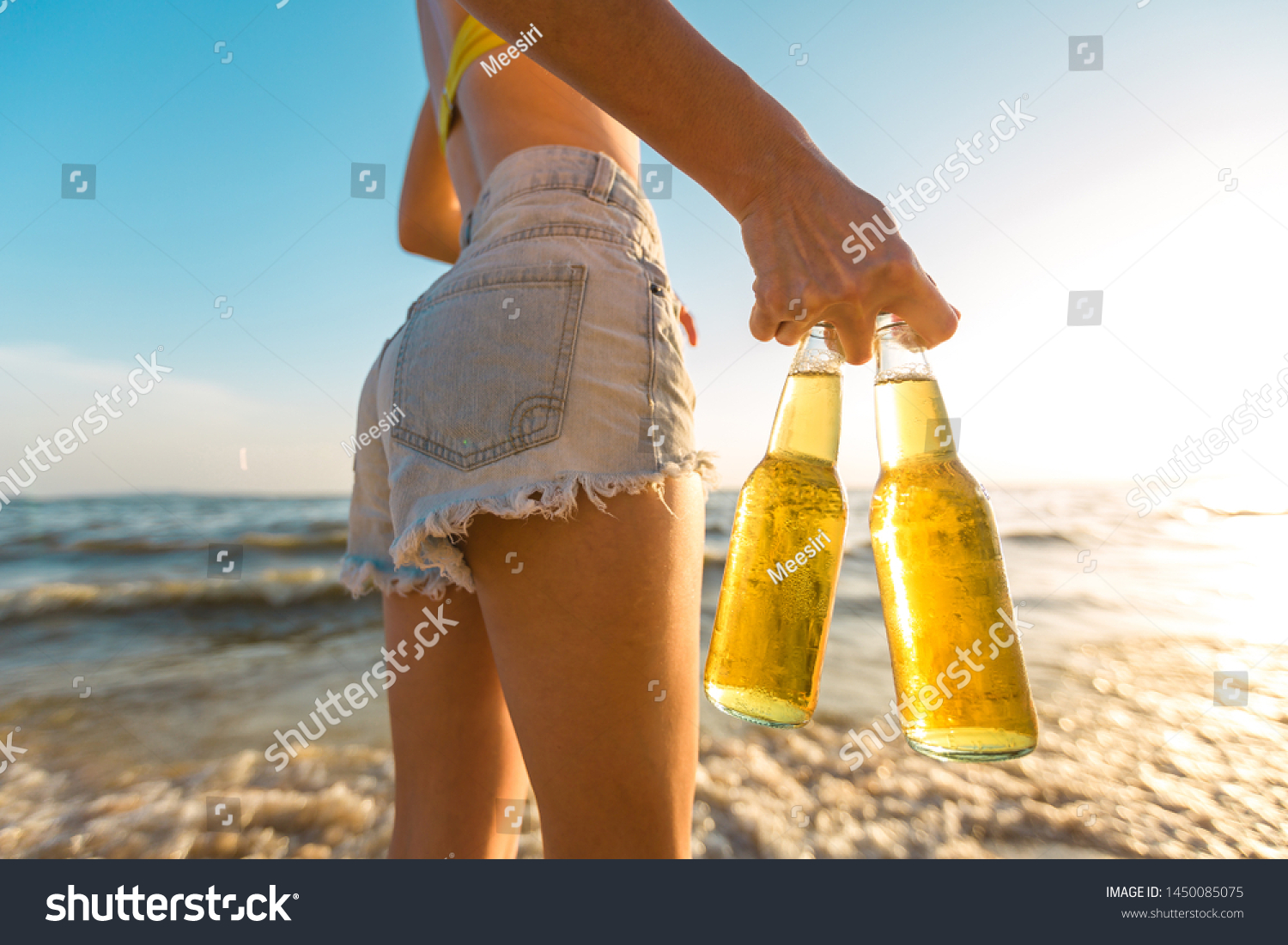 Download Girl Yellow Bikini Short Holding Bottle Stock Photo Edit Now 1450085075 PSD Mockup Templates