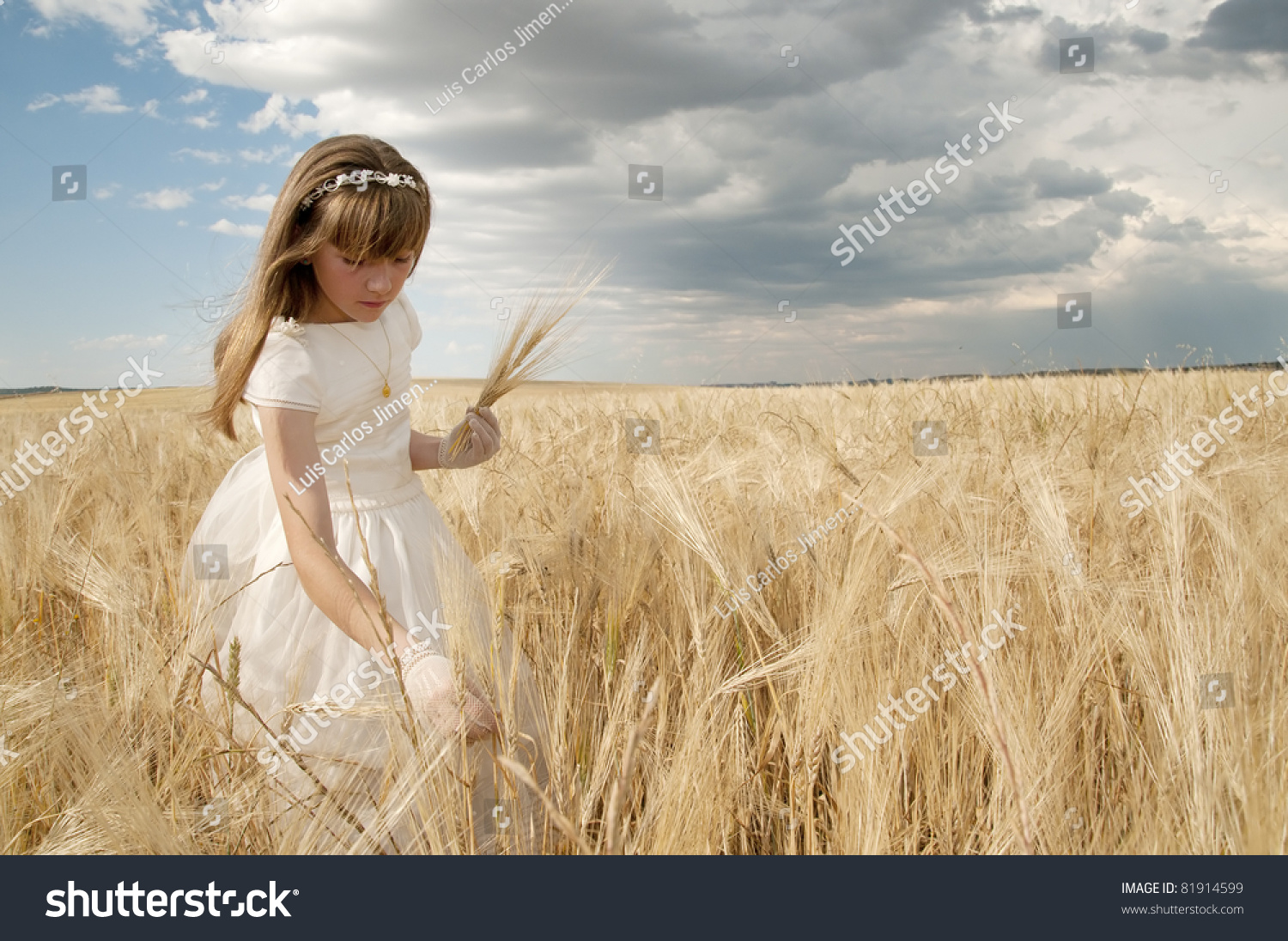 girl wearing first communion dress among the spikes