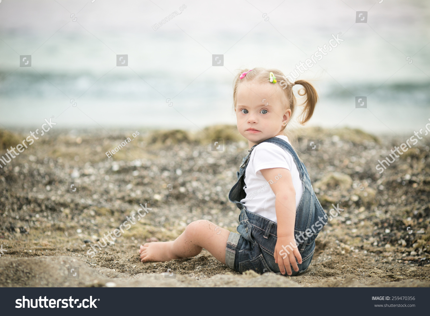 Girl With Down Syndrome Funny Crawling On The Beach Stock Photo ...