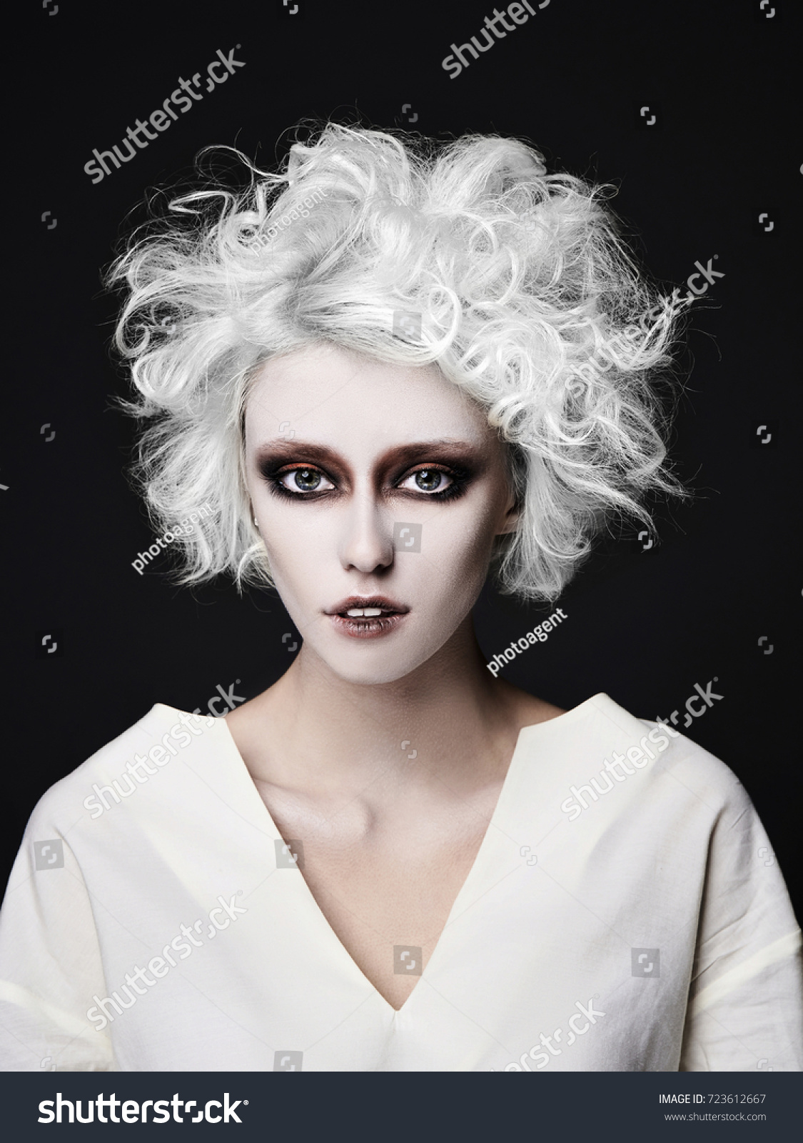 stock photo girl with scary clown make up for halloween blond young woman with white skin wear straitjacket 723612667